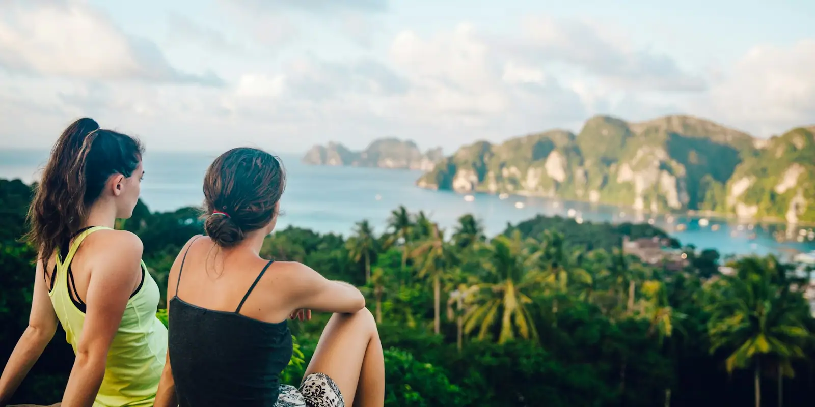 Travellers sitting on a hilltop viewpoint