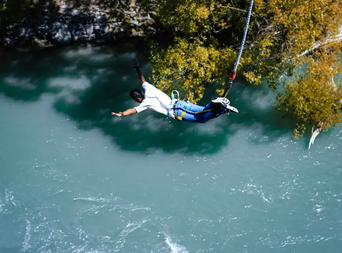 Man mid-air during a bungee jump