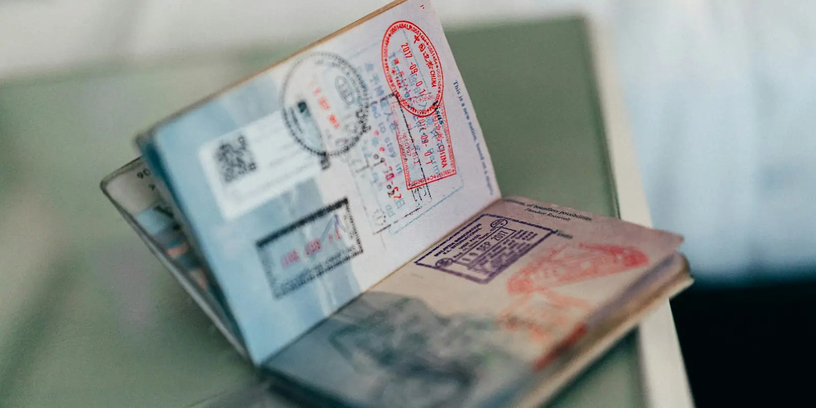 Open passport with colourful visa stamps