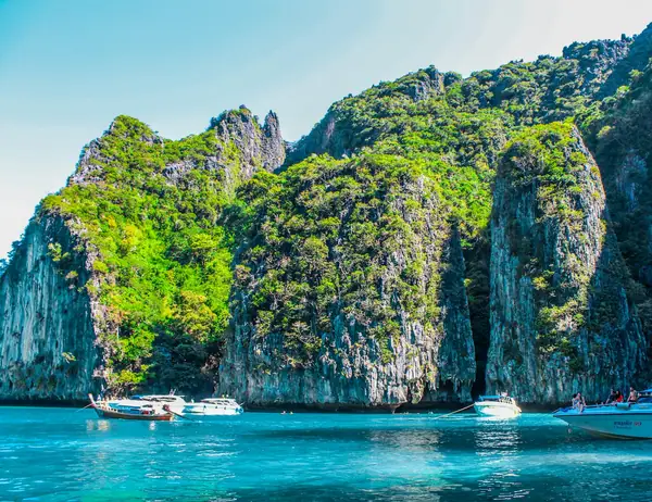 Longtail boat beneath limestone cliffs in Krabi