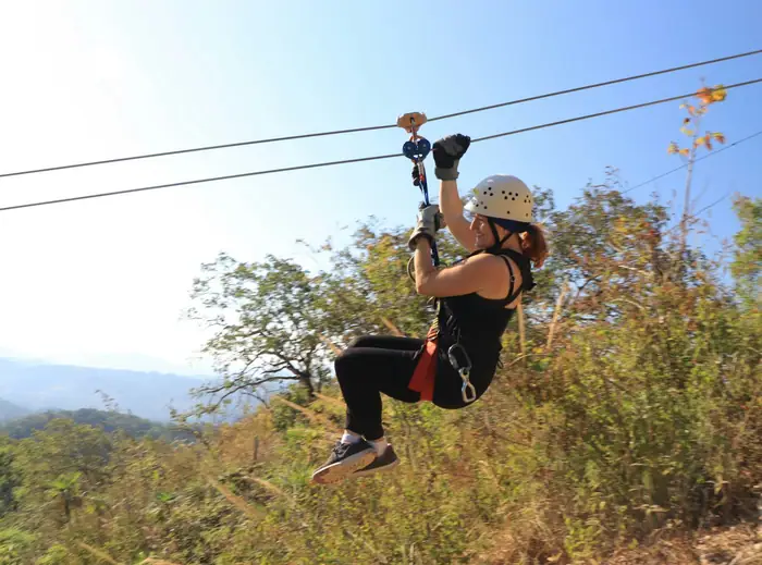 Traveller zipping through the air on a zip line